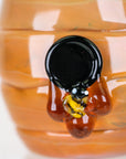 Close-up of Save the Bees Proxy Core attachment showing a miniature sculpted bee on honey-colored glass