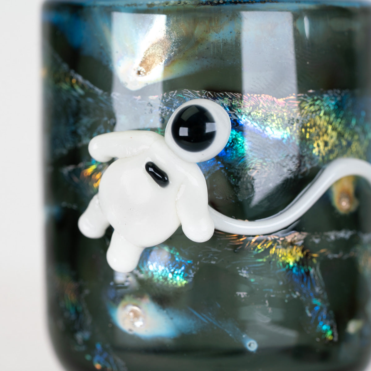 Close-up of Across the Universe Proxy Core attachment showing intricate space-themed lampwork and shimmering colors
