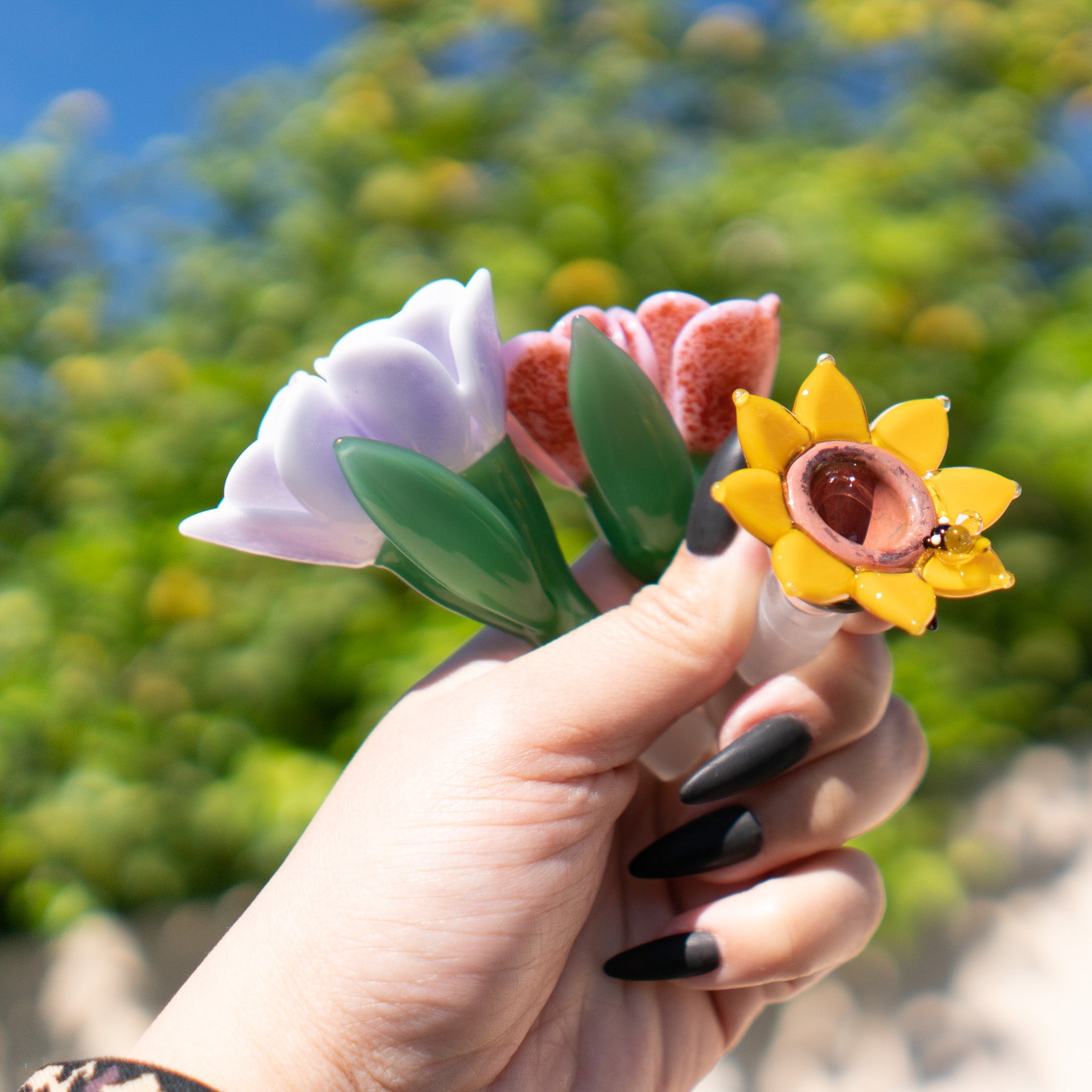 Detailed glass craftsmanship from Empire Glassworks shown on three flowers made by hand