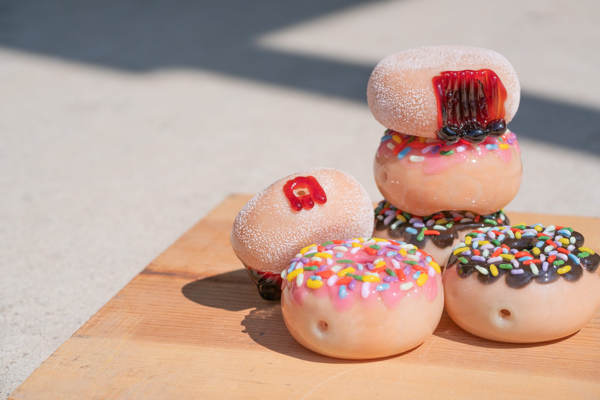 Empire Glassworks handcrafted functional glass collection of donut pipes.