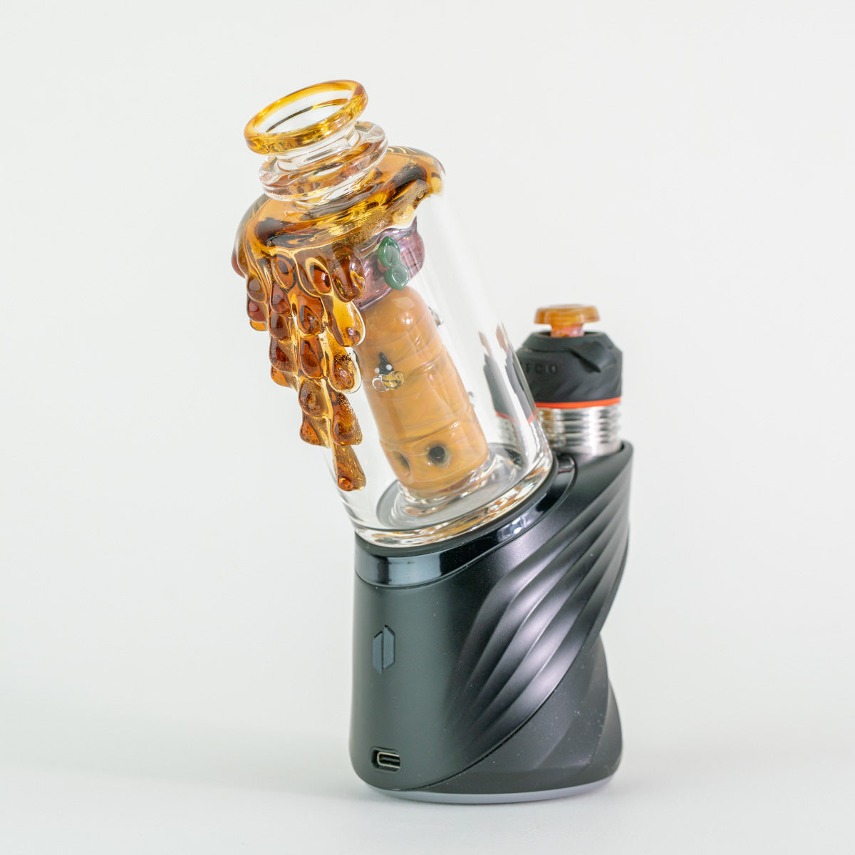 Side view of Empire Glassworks Save the Bees attachment on Puffco Peak Pro highlighting sculpted bees and honeycomb texture