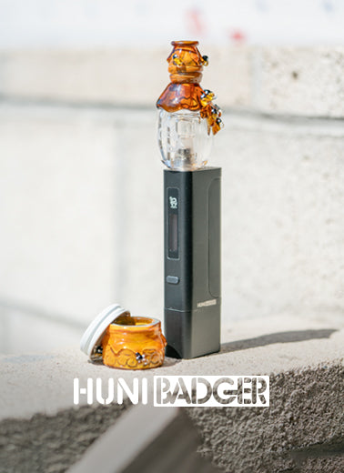 A bee-themed, glass huni dabber top and terp jar made by Empire Glassworks for the brand Huni Dabber