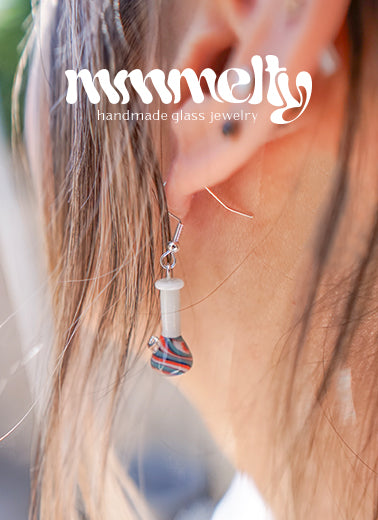A woman wearing a glass earring shaped like a bong from Mmmelty