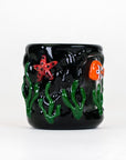 Empire Glassworks Puffco Proxy Core attachment featuring sculpted marine life against a glossy black glass background